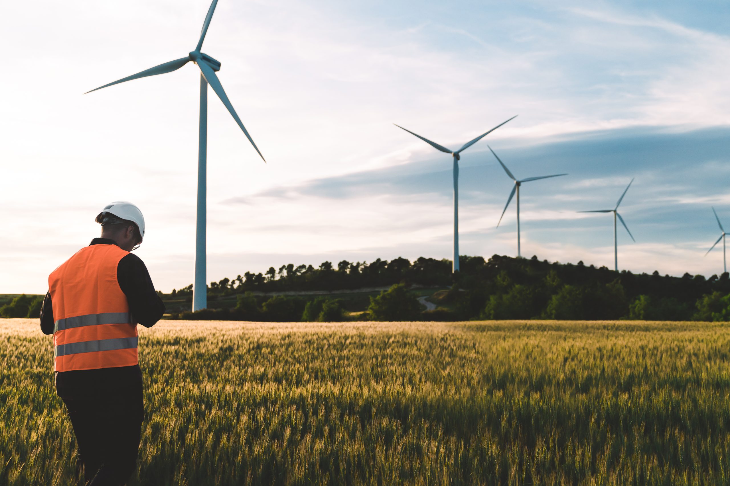 Engineer working at alternative renewable wind energy farm – Sustainable energy industry concept