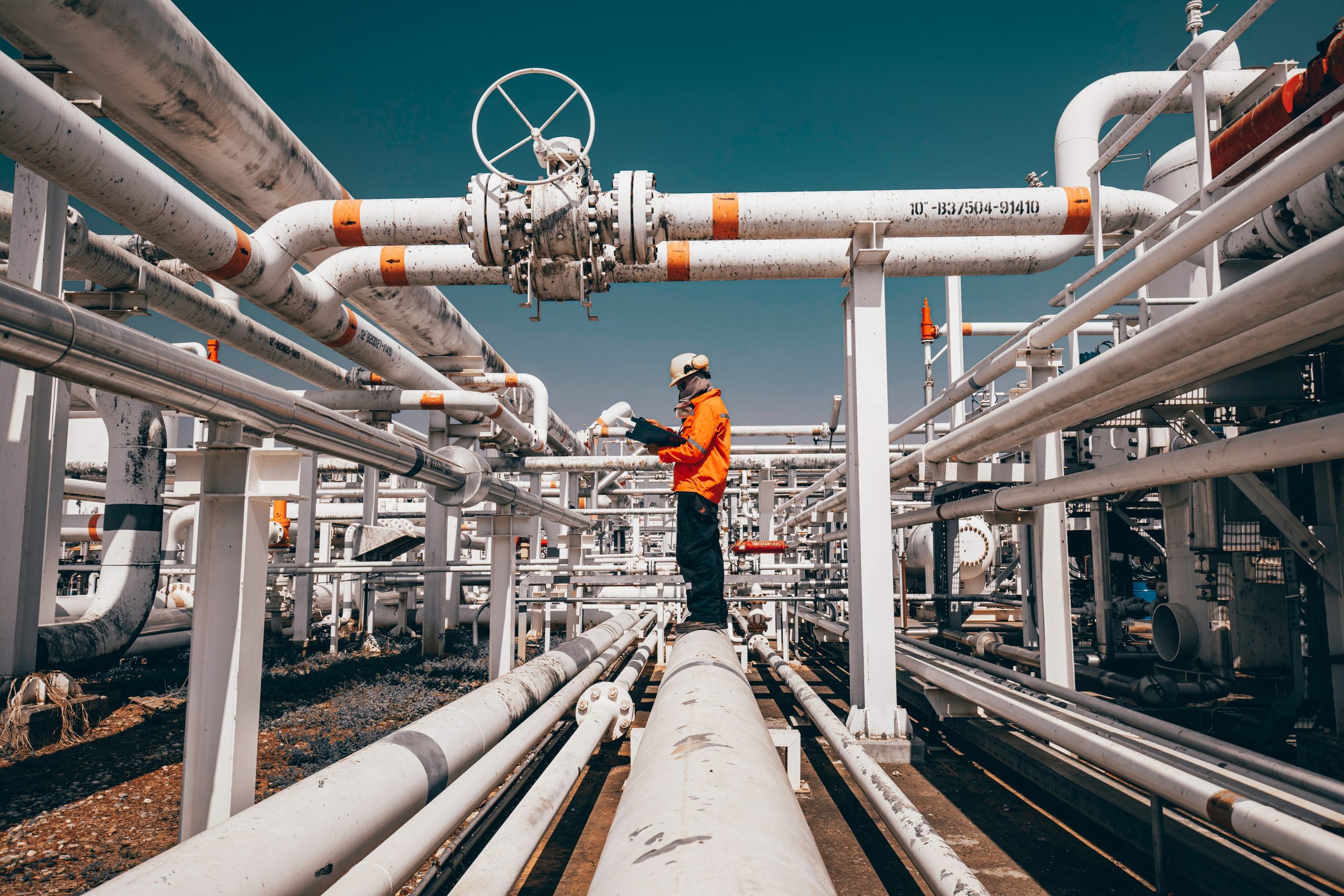Top,View,Male,Worker,Inspection,At,Steel,Long,Pipes,And